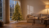 A pre-lit Christmas tree beside an unlit one